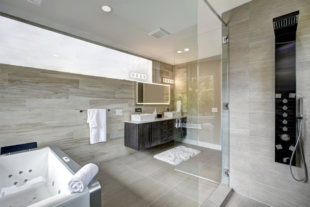Contemporary master bathroom features a dark vanity cabinet fitted with rectangular his and hers sink, jetted tub and walk-in shower. Northwest, USA